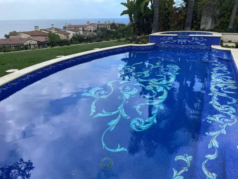 Blue mosaic pool mural with intricate floral design, perfect for luxury outdoor pools and custom mos.