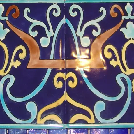 Blue mosaic pool tile with intricate gold and light blue patterns for luxury pool design.