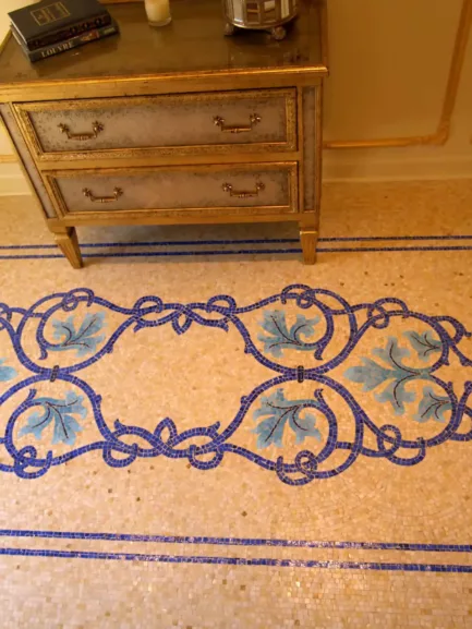 Beautiful mosaic floor with detailed blue and gold floral motifs and ornate border.